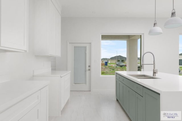 8879 Wentz Lk, Brownsville, TX 78520 - kitchen with light countertops, white cabinets, and hanging light fixtures