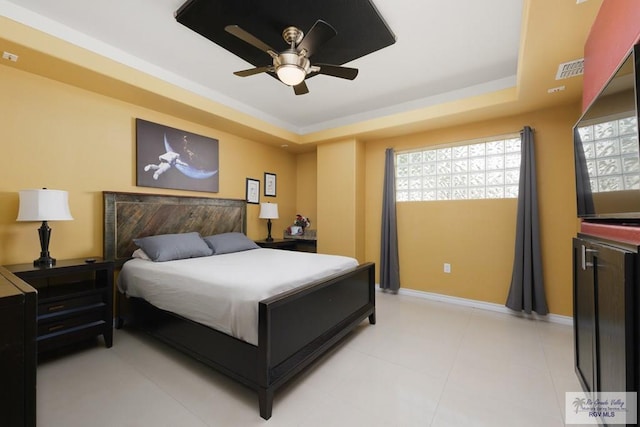 bedroom featuring a tray ceiling and ceiling fan