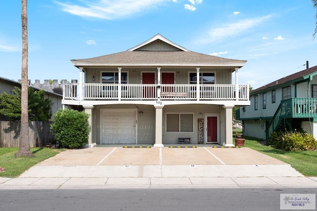 view of front of house featuring a garage and a balcony