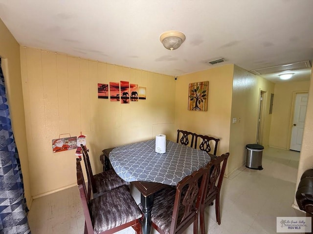 dining space with visible vents and attic access