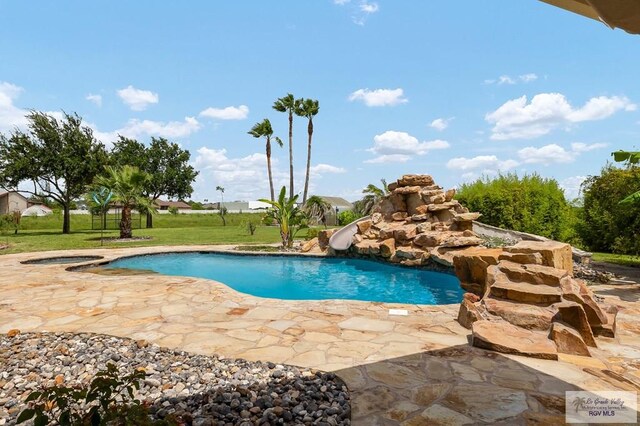 view of pool with a lawn, a patio area, and a water slide