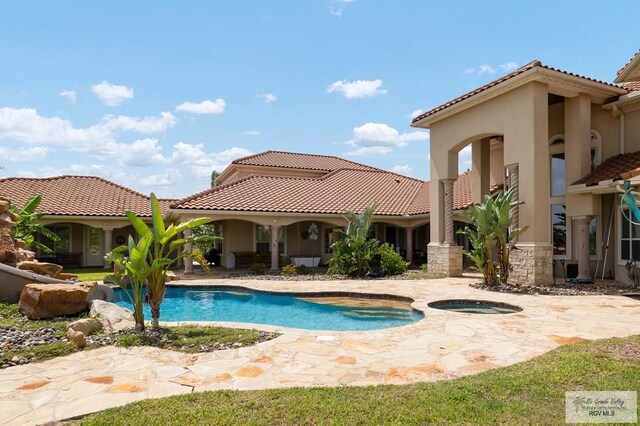 view of pool featuring an in ground hot tub and a patio