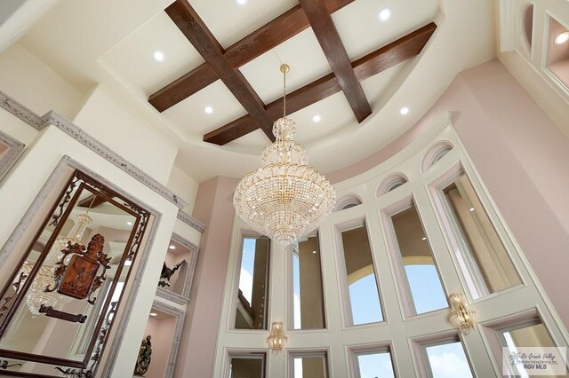 interior details with beamed ceiling, a notable chandelier, and coffered ceiling