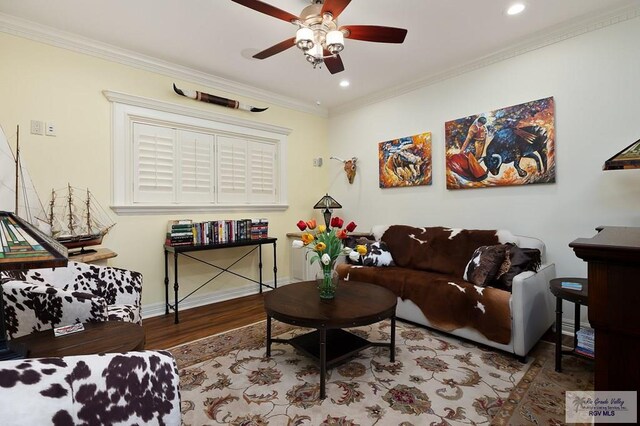 living room with ceiling fan, wood-type flooring, and ornamental molding