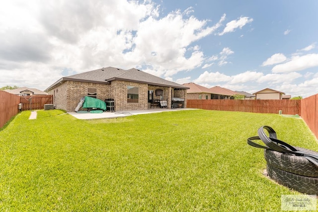 back of house featuring a yard and a patio