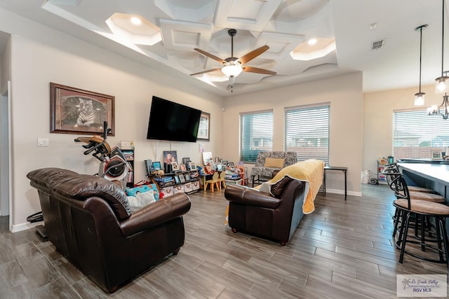 living room with ceiling fan, coffered ceiling, and light wood-type flooring