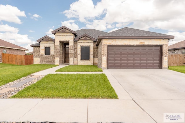 view of front of house with a front yard and a garage