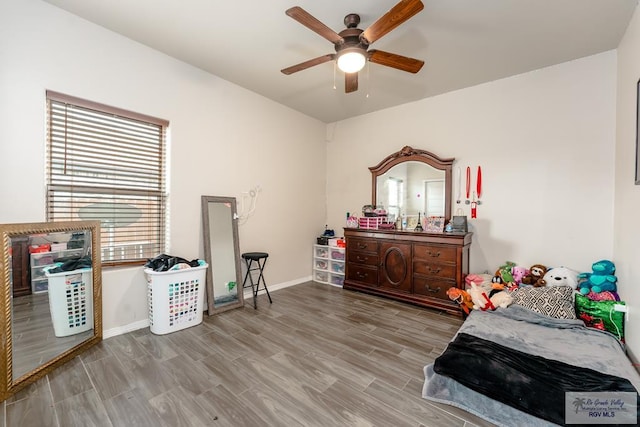 bedroom with light hardwood / wood-style flooring and ceiling fan