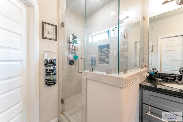 bathroom featuring vanity and an enclosed shower