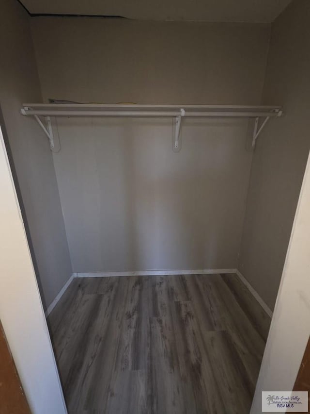 spacious closet with wood finished floors