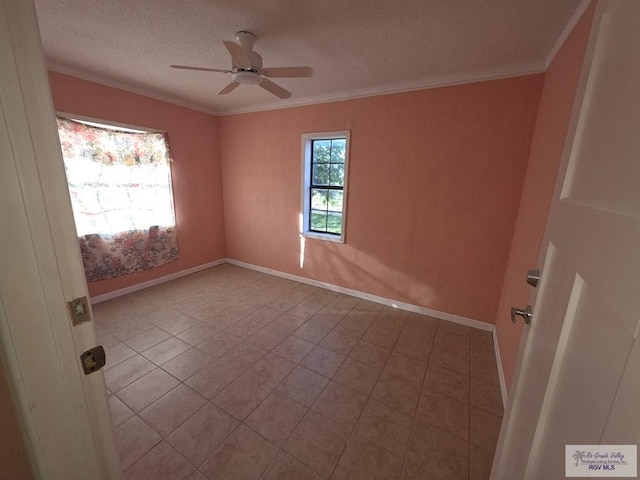 empty room featuring a textured ceiling, ceiling fan, crown molding, and tile patterned flooring