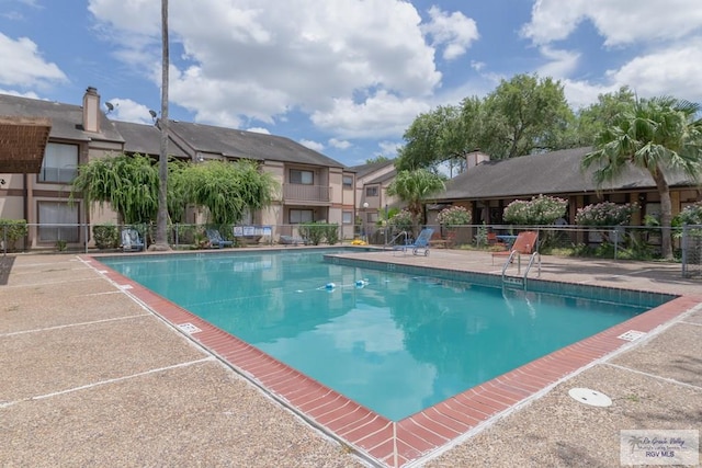 view of swimming pool with a patio area