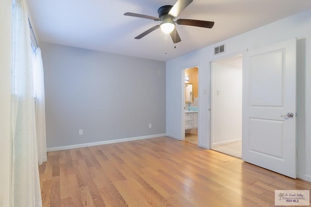 unfurnished bedroom with ensuite bathroom, ceiling fan, and light hardwood / wood-style flooring