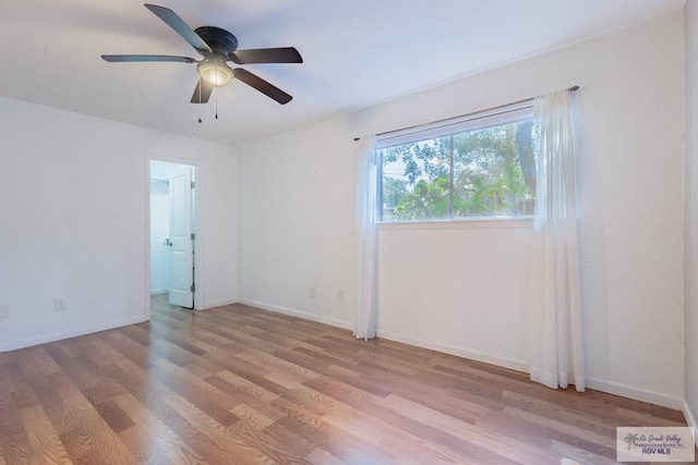 spare room with ceiling fan and light wood-type flooring