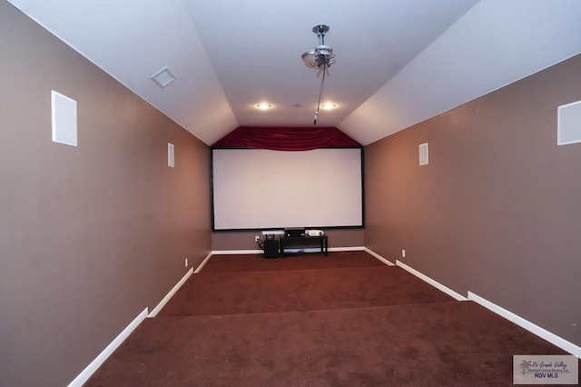 home theater featuring carpet flooring and vaulted ceiling