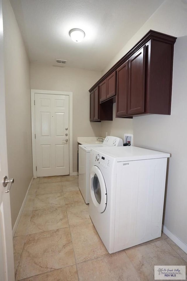 laundry area with cabinets and washing machine and dryer