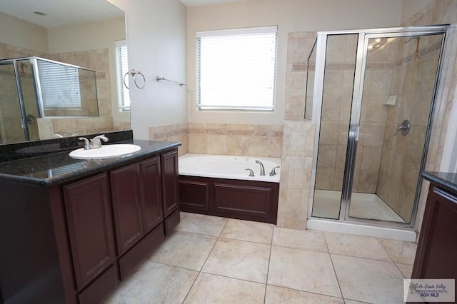 bathroom with tile patterned floors, vanity, and separate shower and tub