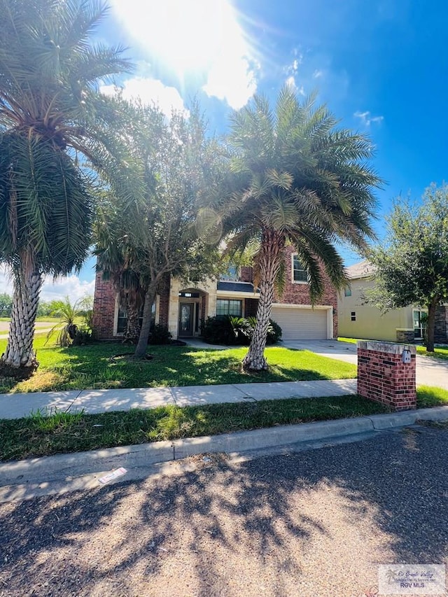 view of front of property featuring a front lawn and a garage