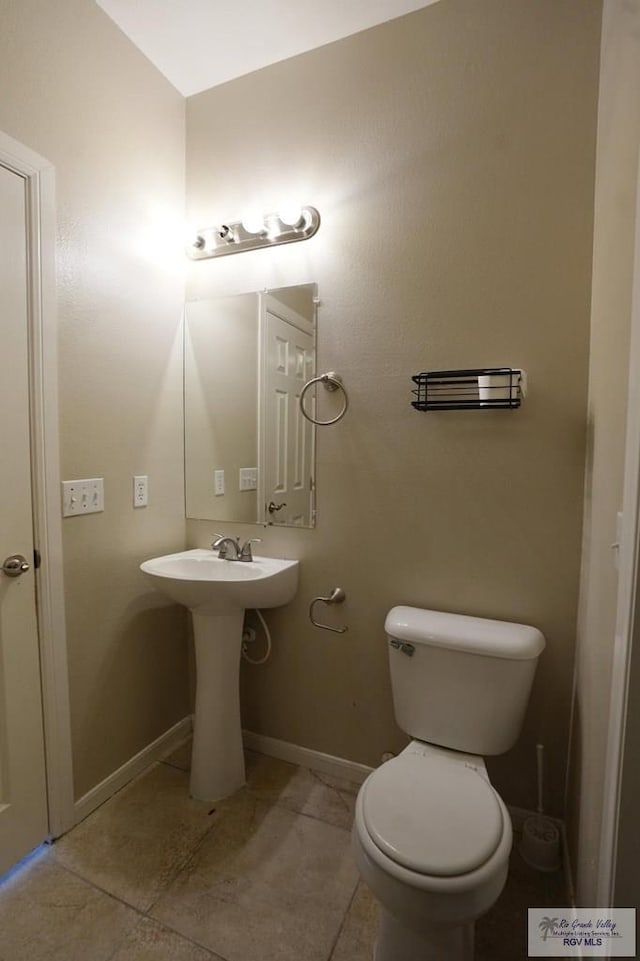 bathroom with tile patterned floors, toilet, and sink