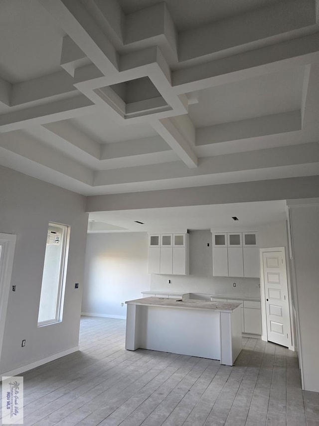 kitchen featuring white cabinetry, a kitchen island, and light hardwood / wood-style flooring