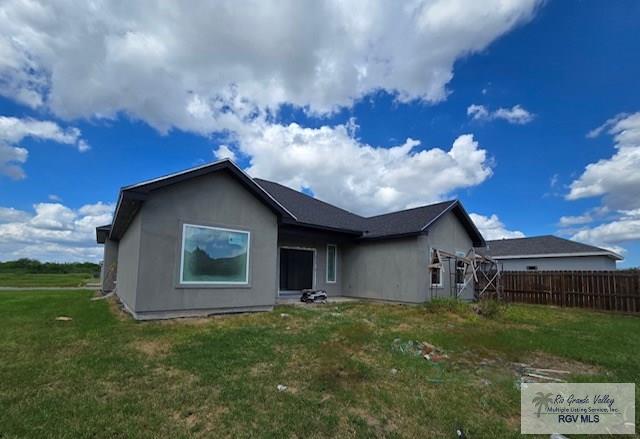 rear view of house with a lawn