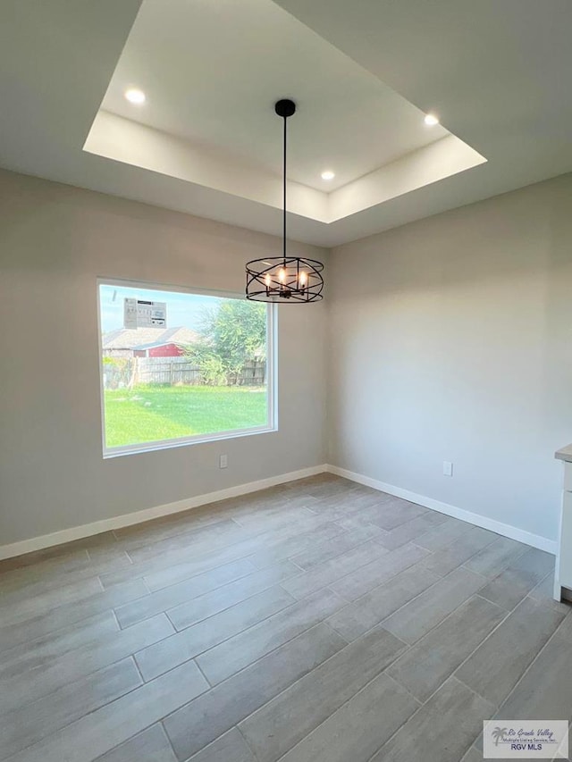 105 Republic Cir, San Benito, TX 78586 - unfurnished room with a raised ceiling, recessed lighting, a chandelier, and baseboards