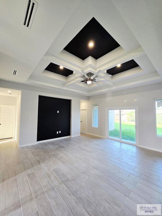 105 Republic Cir, San Benito, TX 78586 - unfurnished living room featuring ceiling fan, baseboards, light wood finished floors, and coffered ceiling