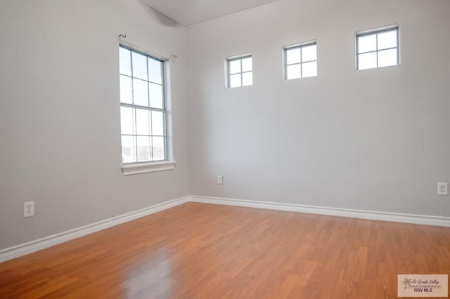 spare room with hardwood / wood-style flooring