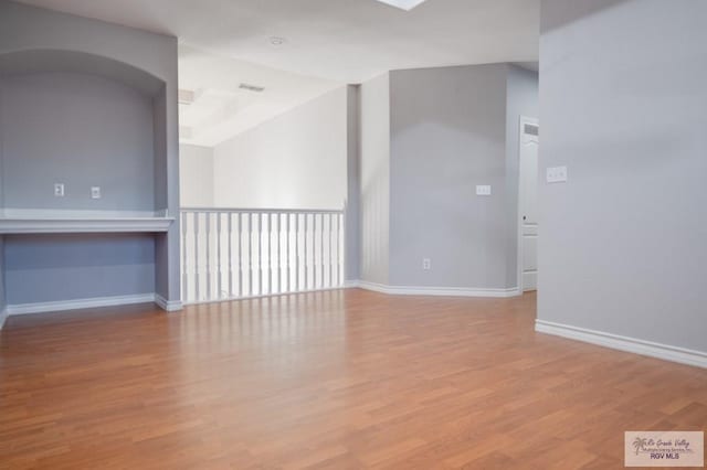 spare room featuring light wood-type flooring