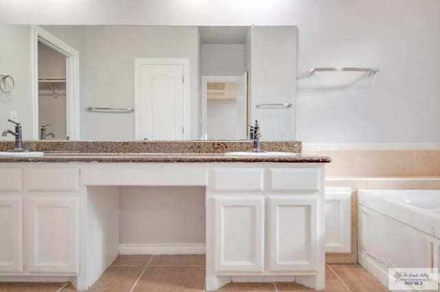 6724 Pino Verde Dr, Brownsville, TX 78526 - full bathroom featuring double vanity, a garden tub, tile patterned floors, and a sink