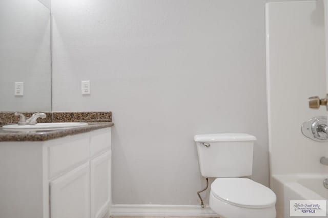 full bathroom featuring shower / bathing tub combination, vanity, and toilet