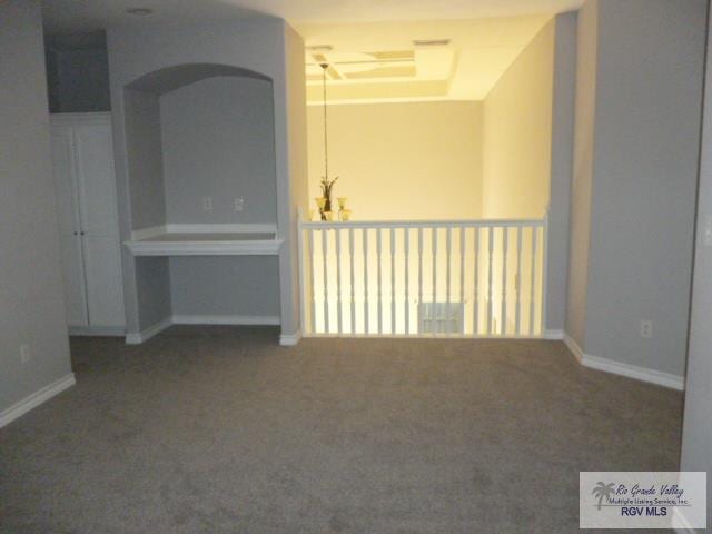 6724 Pino Verde Dr, Brownsville, TX 78526 - carpeted spare room with a tray ceiling and baseboards