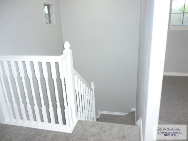 empty room featuring ceiling fan, tile patterned flooring, and coffered ceiling