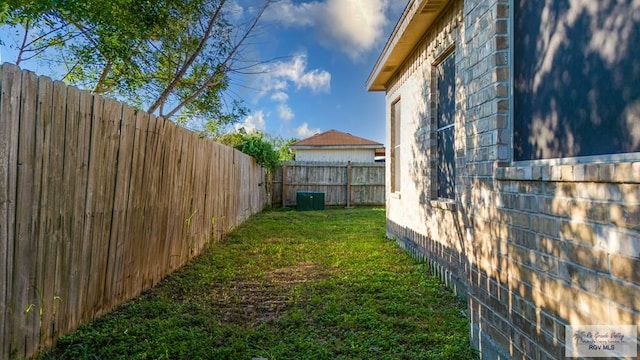 6724 Pino Verde Dr, Brownsville, TX 78526 - view of property exterior with a yard, stone siding, and a fenced backyard