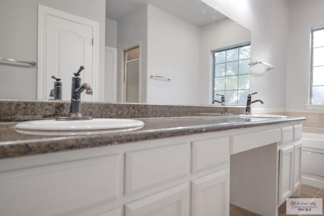 bathroom with vanity and independent shower and bath