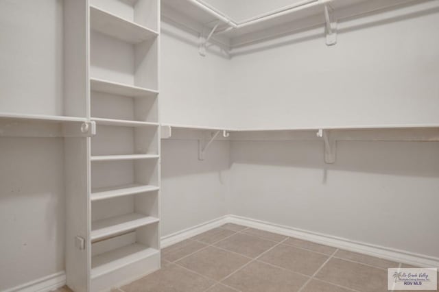 spacious closet with tile patterned floors