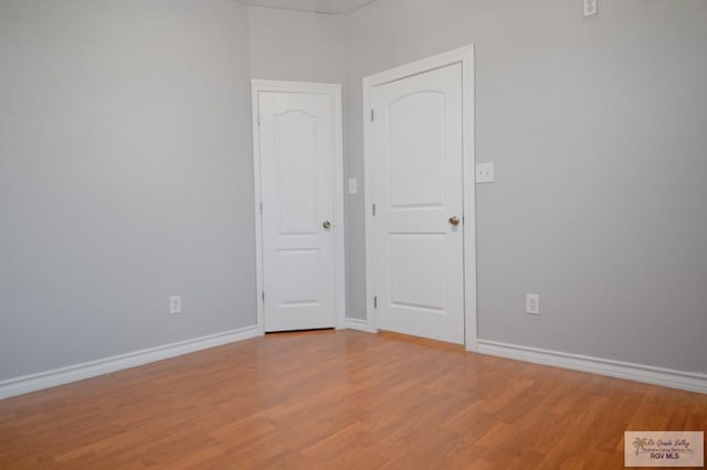 unfurnished room with hardwood / wood-style flooring