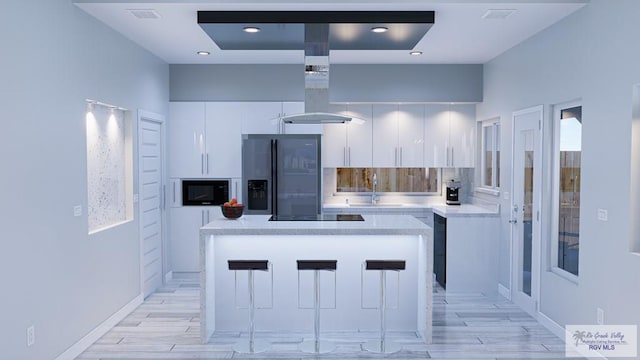 kitchen with white cabinetry, a kitchen island, sink, and black appliances