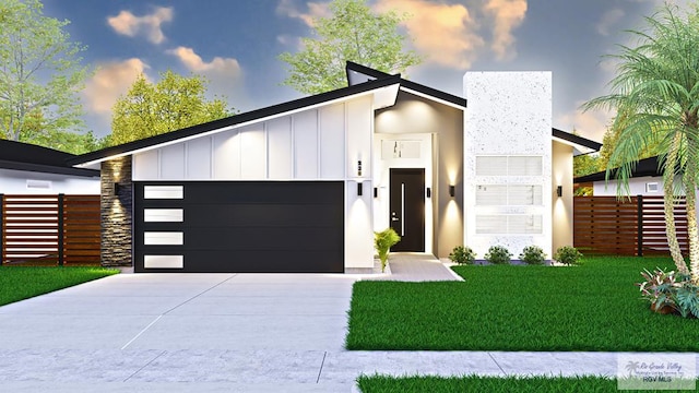 contemporary house featuring elevator, a yard, and a garage