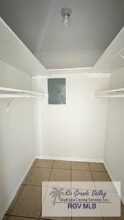 spacious closet featuring tile patterned flooring and electric panel