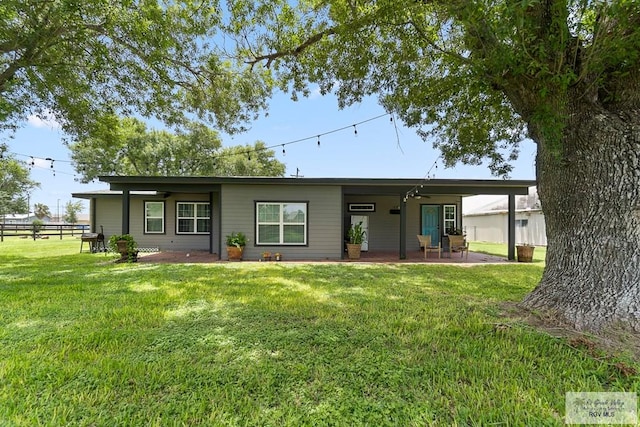 back of house featuring a lawn