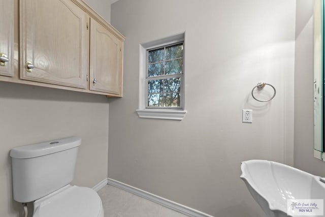 bathroom featuring sink, tile patterned flooring, and toilet