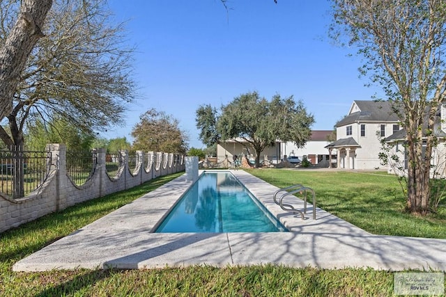 view of pool with a yard