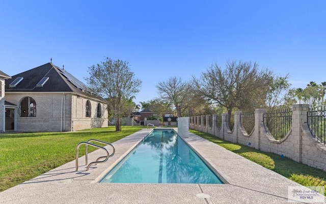 view of swimming pool with a lawn