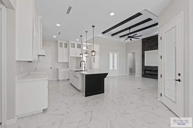 446 Parker Rd, La Feria, TX 78559 - kitchen featuring ceiling fan, light marble finish flooring, white cabinetry, a sink, and recessed lighting