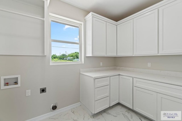 446 Parker Rd, La Feria, TX 78559 - laundry room featuring electric dryer hookup, hookup for a washing machine, cabinet space, light marble finish flooring, and baseboards
