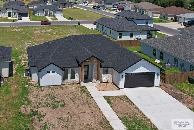 446 Parker Rd, La Feria, TX 78559 - view of front facade with a residential view, a garage, fence, and concrete driveway