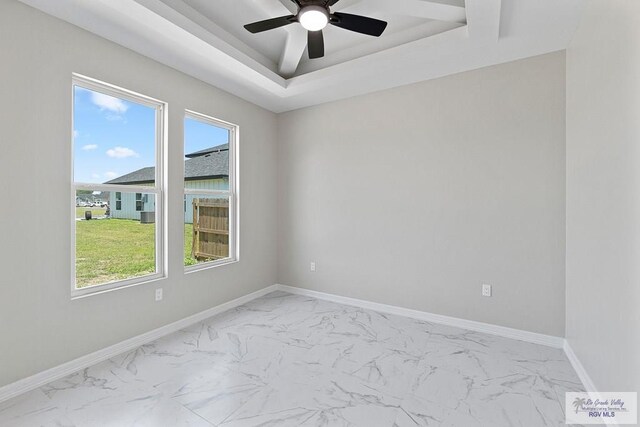 446 Parker Rd, La Feria, TX 78559 - unfurnished room with light marble finish flooring, a ceiling fan, and baseboards