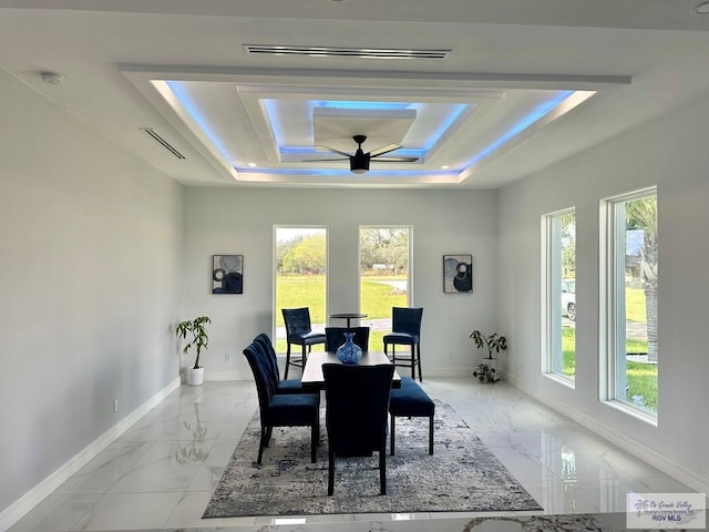 dining space featuring a tray ceiling and ceiling fan