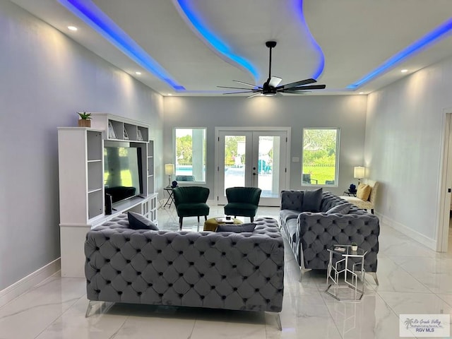 living room with ceiling fan and french doors